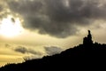 Mountaineers reaching the top of a mountain at sunset with threatening clouds in the sky Royalty Free Stock Photo