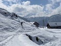 Mountaineers and skiers on the beautiful idyllic fresh snow in the Alpstein mountain massif and in Swiss Alps, Nesslau