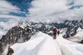 Mountaineers on the top of a snowy mountain in the Alps