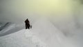 Mountaineers walking up along a snowy ridge with backpack