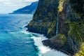 Mountainous coastal landscape of Madeira island, waterfall crossing coastal road Royalty Free Stock Photo