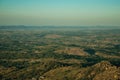 Mountainous landscape covered by trees and cultivated fields Royalty Free Stock Photo