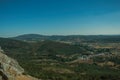 Mountainous landscape covered by trees and cultivated fields Royalty Free Stock Photo