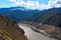 A mountainous landscape with a large dewatered mountain river Royalty Free Stock Photo