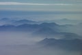 Mountainous peaks exposed through cloud