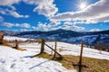 mountainous rural landscape on a sunny winter day. fields and trees on rolling hills covered in snow Royalty Free Stock Photo