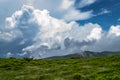 Mountainpeakll with green grass and blue sky. Fantastic shot