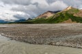 Mountains Tower Over a Gravel Flat in Alaska`s Denali National Park Royalty Free Stock Photo