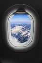 Mountains Alps at Austria in airplane window Royalty Free Stock Photo