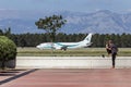 Antalya, Turkey - May 2016: A tourist observes an airplane landing at the Antalya airport.