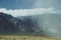 Mountains behind grassy paddocks