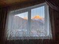 Mountains behind window with curtain
