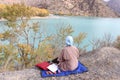 Mountains blue lake yellow trees fog autumn girl picnic apples grapes thermos book. Royalty Free Stock Photo