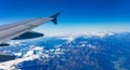 Mountains and blue sky. View out of an airplane window. Royalty Free Stock Photo