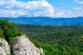 Mountains with Christmas trees against the blue sky with clouds. Beautiful panoramic view of firs and larches coniferous forest Royalty Free Stock Photo