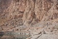 Mountains and clean water lake in beautiful persian valley with historical rocky reliefs