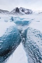 Mountains with clouds on Antarctica. Glaciers, icebergs and ice caves of Southern hemisphere. Global climate change on Earth.