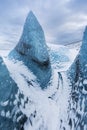 Mountains with clouds on Antarctica. Glaciers, icebergs and ice caves of Southern hemisphere. Global climate change on Earth.