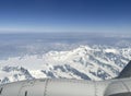 Mountains and clouds out a plane window Royalty Free Stock Photo