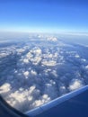 Mountains and clouds out a plane window Royalty Free Stock Photo