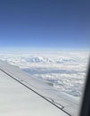 Mountains and clouds out a plane window Royalty Free Stock Photo