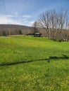 Farm house Fences trees mountains clouds sky green grass fields trees country drive