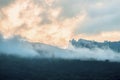 Mountains in clouds at sunset Royalty Free Stock Photo