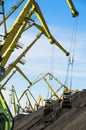 Industrial of portal crane buckets and giant coal heaps