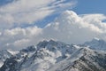 Mountains covered in snow with clouds in background