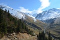 Mountains covered in snow with clouds in background