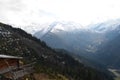 Mountains covered in snow with clouds in background