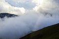 Mountains in the dense clouds in the summer sunny day Royalty Free Stock Photo