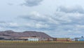 Mountains of empty ore when mining potassium on cloudy sky background. Transportation of an empty rock to a dump. Royalty Free Stock Photo