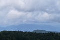 Mountains, fields and forest in cloudy weather. Nature and landscape of national Park in Caucasus. Dense coniferous green summer Royalty Free Stock Photo