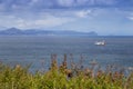 Mountains and a fishing boat near Yuzhno-Kurilsk city, Kunashir Island, Russia