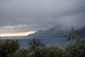 Mountains in the fog above the sea bay in the background. In the foreground is a park. Italian coastal landscape Royalty Free Stock Photo