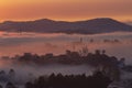 Mountains in fog at beautiful morning in autumn in Dalat city, Vietnam. Royalty Free Stock Photo