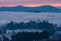 Mountains in fog at beautiful morning in autumn in Dalat city, Vietnam. Royalty Free Stock Photo