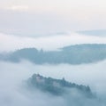 Mountains in fog at beautiful morning in autumn. Landscape with mountain valley, low clouds, forest, colorful sky , nature. Royalty Free Stock Photo