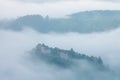 Mountains in fog at beautiful morning in autumn. Landscape with mountain valley, low clouds, forest, colorful sky , nature. Royalty Free Stock Photo