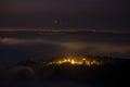 Mountains in fog at beautiful night in autumn in Dalat city, Vietnam. Royalty Free Stock Photo