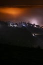 Mountains in fog at beautiful night in autumn in Dalat city, Vietnam. Royalty Free Stock Photo