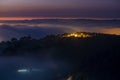 Mountains in fog at beautiful night in autumn in Dalat city, Vietnam. Royalty Free Stock Photo