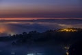 Mountains in fog at beautiful night in autumn in Dalat city, Vietnam. Royalty Free Stock Photo