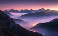 Mountains in fog at beautiful night in autumn in Dolomites, Italy