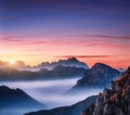 Mountains in fog at beautiful sunset in autumn Royalty Free Stock Photo