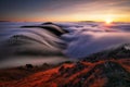 Mountains in fog at beautiful sunset in autumn in Slovakia Landscape with alpine mountain valley, low clouds, forest, purple sky Royalty Free Stock Photo