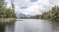 Mountains and forest reflect at Matheson Lake, West Coast, New Zealand Royalty Free Stock Photo