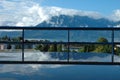Mountains at Geneve lake reflected in water on table.