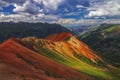 Mountains glow at sunset in Colorado, under fluffy clouds Royalty Free Stock Photo